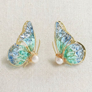 Handmade butterfly earrings with blue-green translucent wings, gold detailing and pearl accent, elegant Western-style jewelry for women in the US and Europe