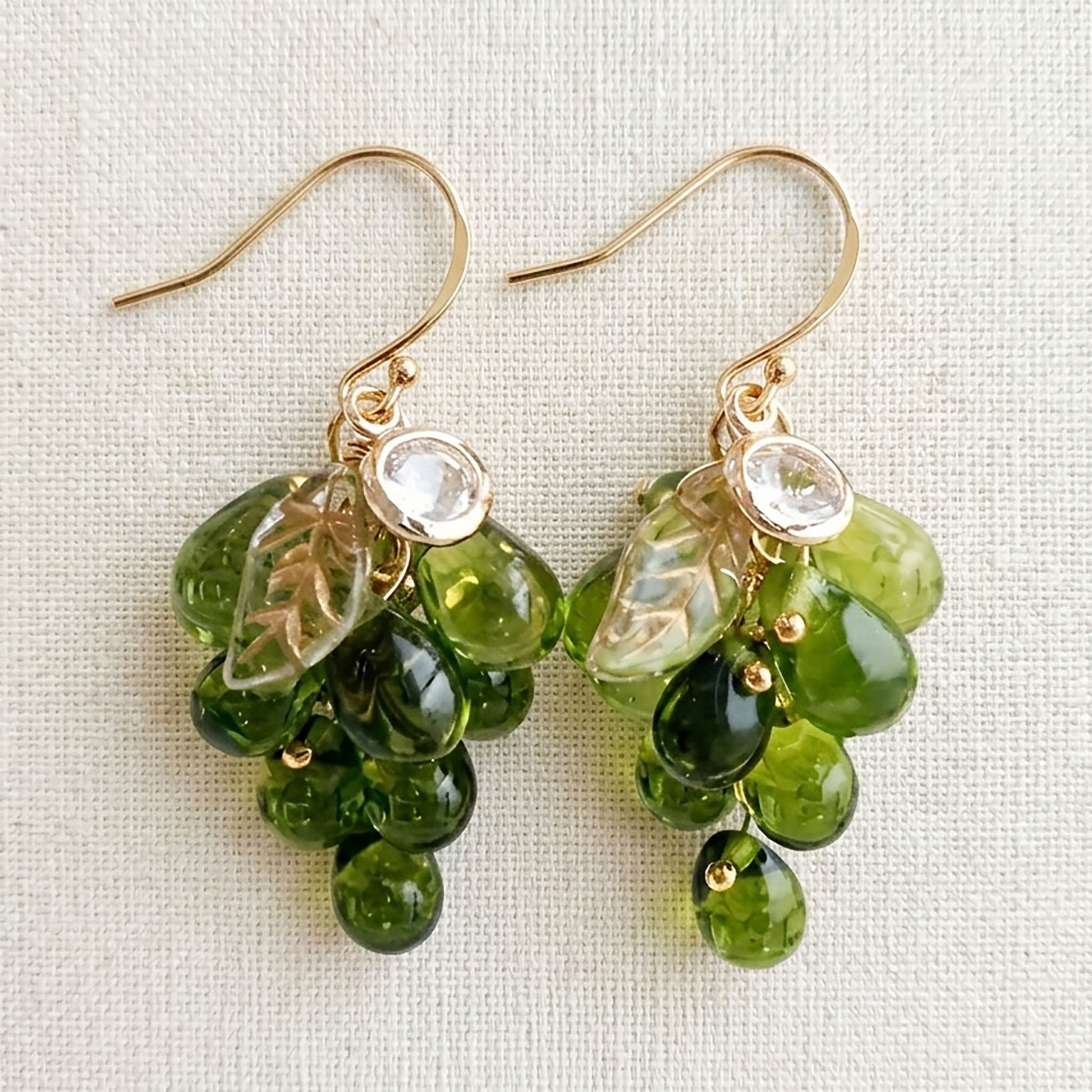 Close-up of purple Czech glass grape earrings showing hand-knotted bead clusters