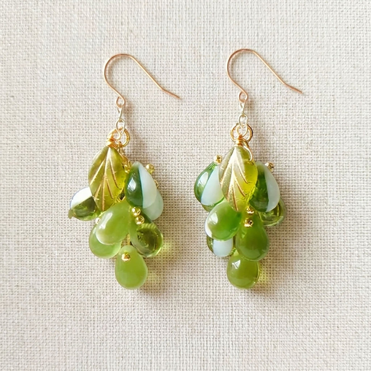 Close-up of purple Czech glass grape earrings showing the intricate hand-wired cluster detail