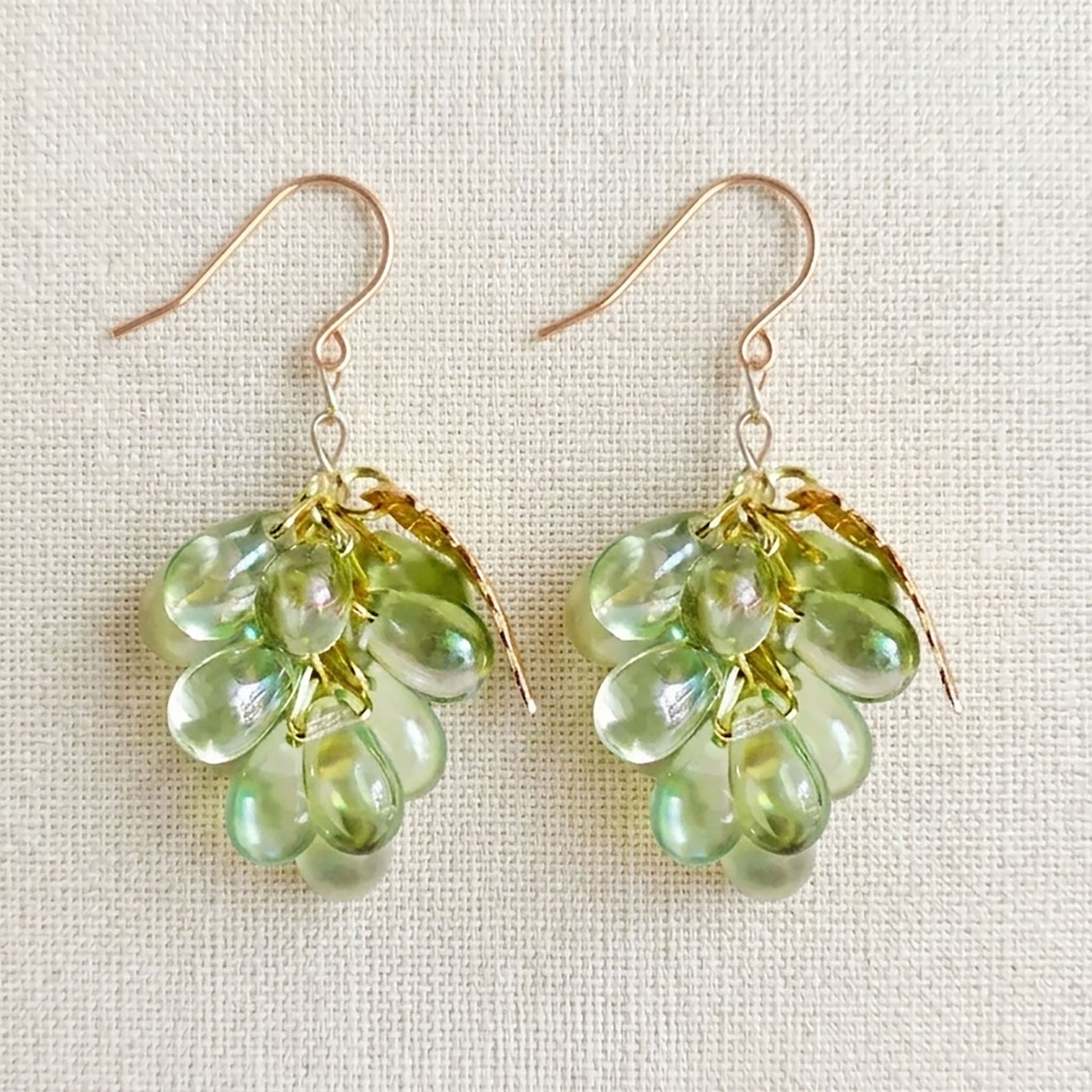 Close-up of realistic purple Czech glass grape earrings featuring hand-wired clusters