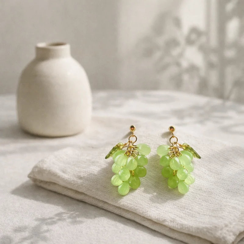 Handmade Czech glass earrings with light green translucent grape beads and gold detailing, nature‑inspired bohemian jewelry for women