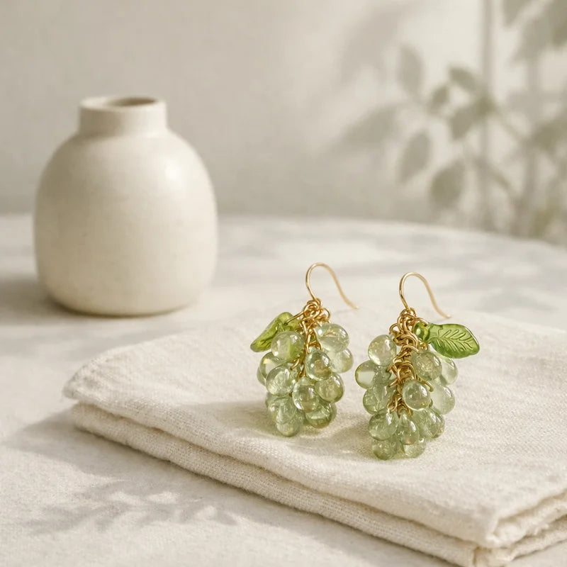 Handmade Czech glass earrings with light green translucent grape beads and green leaf accents, nature‑inspired bohemian jewelry for women
