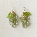 Handmade Czech glass earrings with light green translucent grape beads and green leaf accents, nature‑inspired bohemian jewelry for women