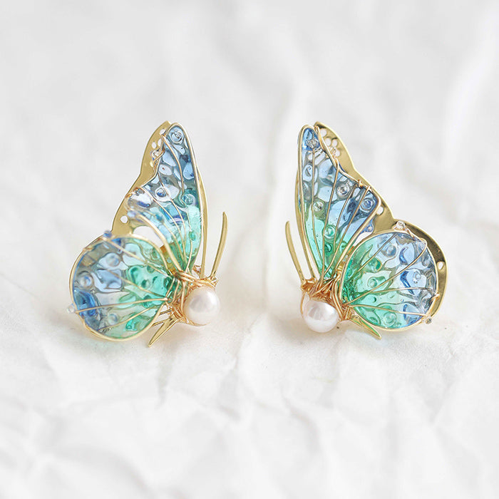 Handmade butterfly earrings with blue‑green gradient wings, gold detailing and pearl accent, elegant Western‑style jewelry for women in the US and Europe