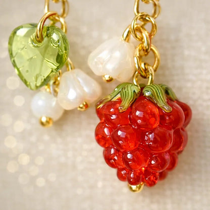 Handmade fruit-inspired charm with red raspberry glass bead, green leaf detail and pearl accents, elegant Western-style jewelry for women in the US and Europe