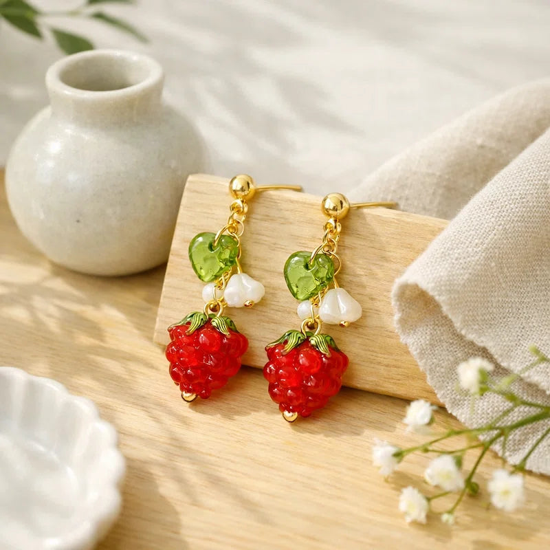 Handmade fruit-inspired earrings with red strawberry charm, green heart leaf and white flower detail, elegant Western-style jewelry for women in the US and Europe