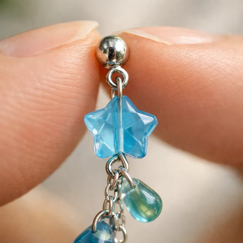 Handmade star‑drop jewelry detail with blue translucent star bead and green‑blue teardrop accents on silver chain, elegant Western‑style accessory for women in the US and Europe