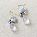 Handmade teardrop crystal earrings with clear gemstone, blue pearl cluster and iridescent accents on gold hook, elegant Western‑style jewelry for women in the US and Europe