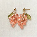 Handmade Czech glass earrings with translucent pink grape beads and green leaf accents, nature-inspired bohemian jewelry for women