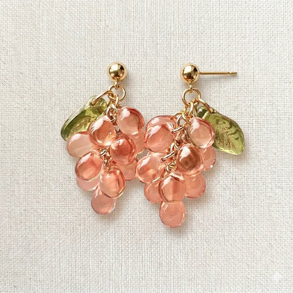Handmade Czech glass earrings with translucent pink grape beads and green leaf accents, nature-inspired bohemian jewelry for women